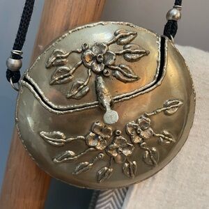 Metal hinged small round purse w floral markings